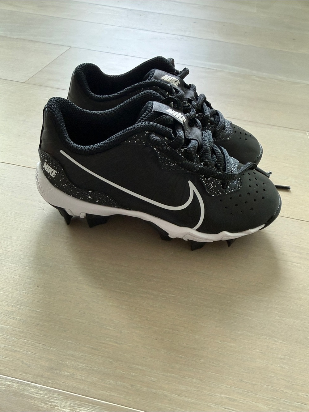 Nike Kids Black and White Cleats with Bold Swoosh